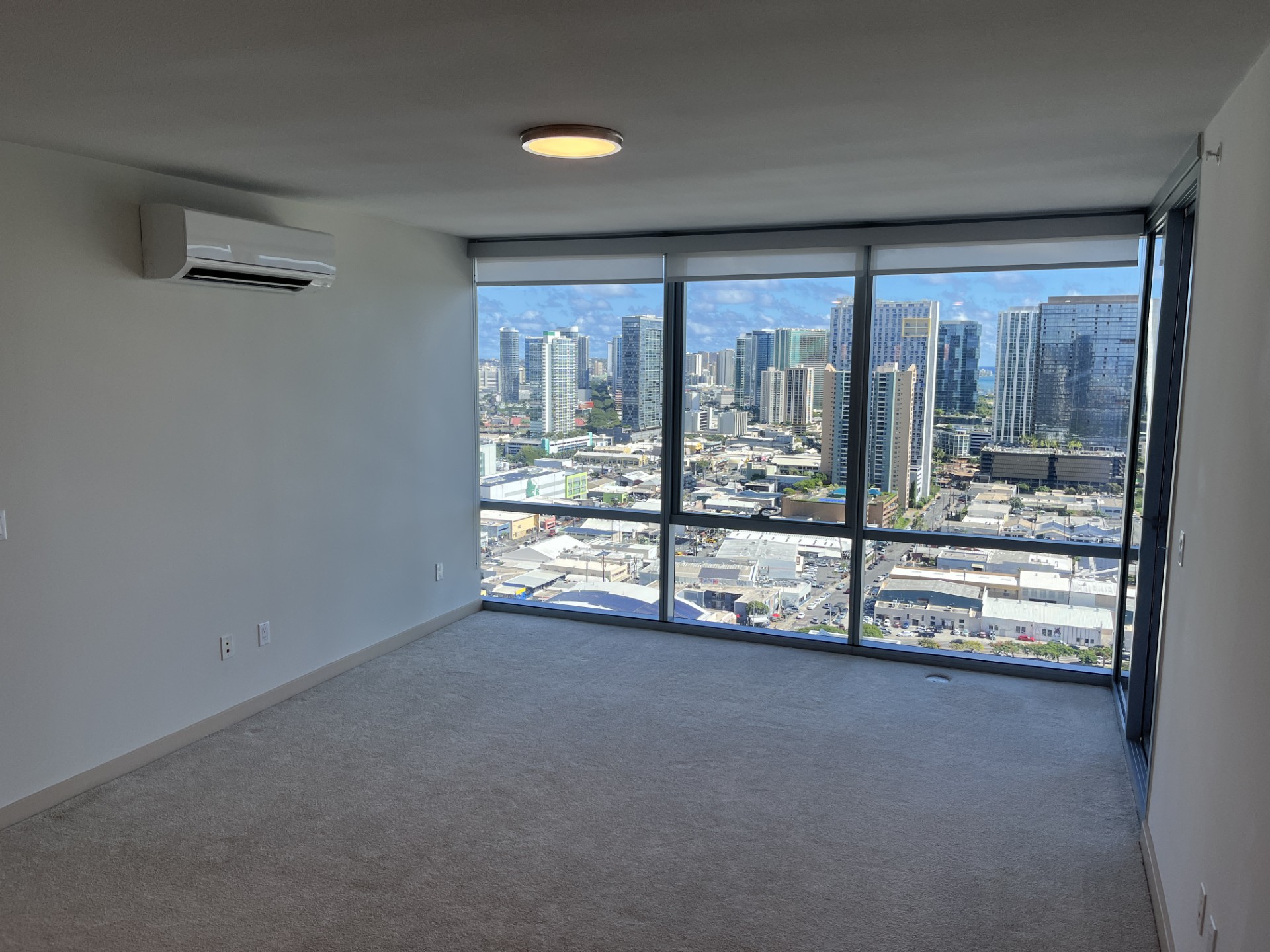 A room with a view of the cityscape outside the window.